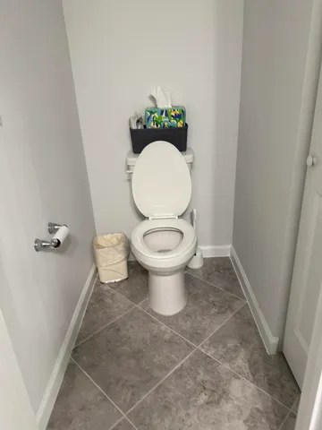 a white toilet sitting next to a sink