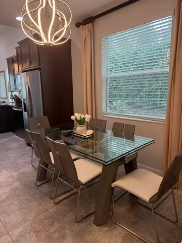 a view of a dining room with furniture window and outside view