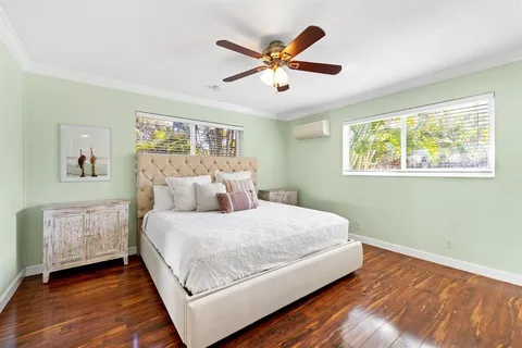a bedroom with a large bed and a chandelier