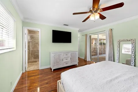 a bedroom with a bed and a flat screen tv