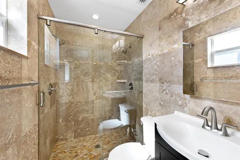a bathroom with a sink toilet and shower