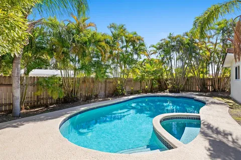 a view of a swimming pool with a yard