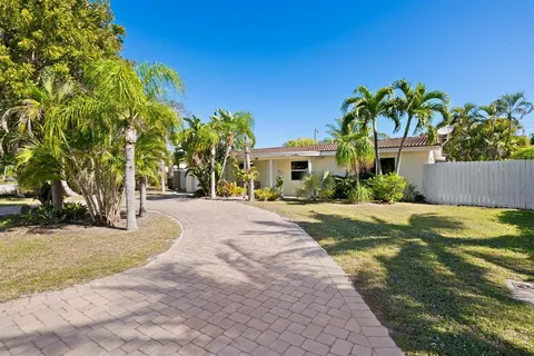 a front view of a house with a yard and a garage