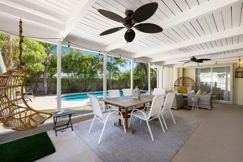 a outdoor space with a large pool table and chairs
