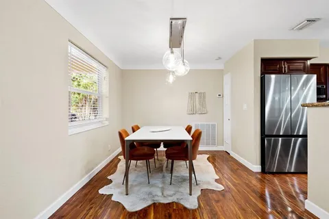 a view of a dining room with furniture and a chandelier