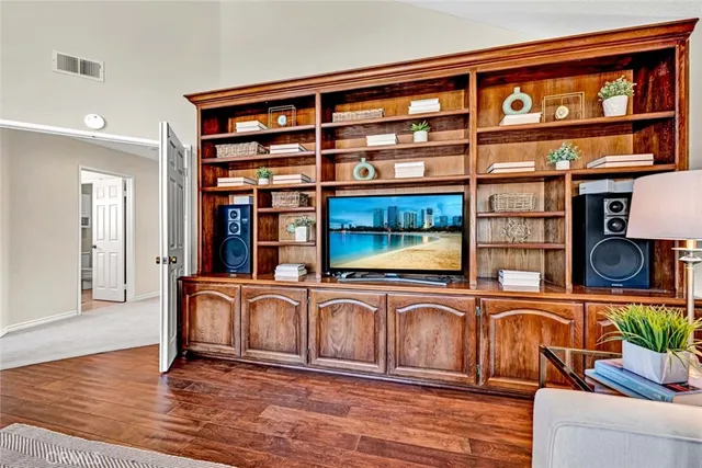 a patio with table and chairs and potted plants