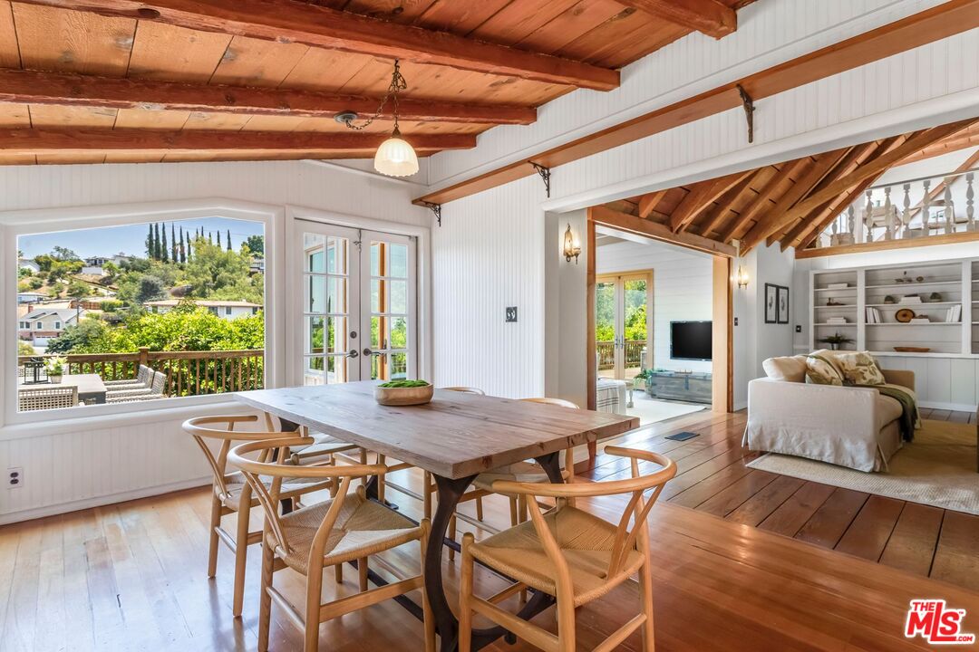 3940 Davana Road Sherman Oaks, CA 91423 - Photo 16 of 60 a view of a dining room with furniture large windows and wooden floor