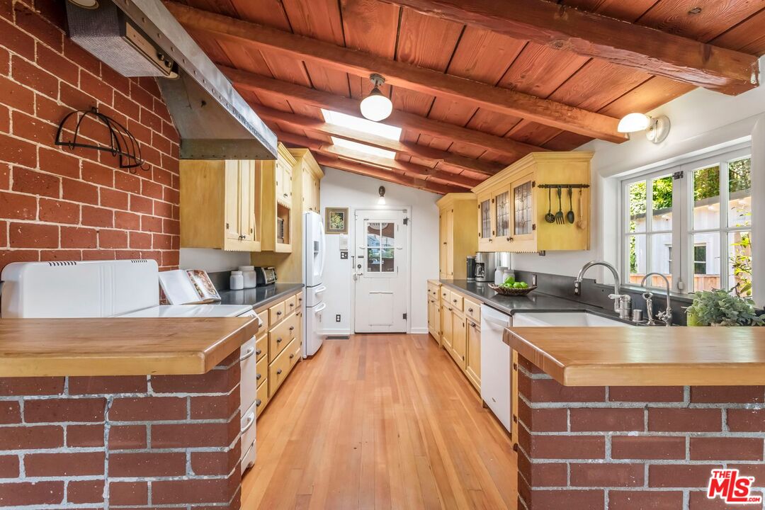 3940 Davana Road Sherman Oaks, CA 91423 - Photo 19 of 60 a large kitchen with a lot of counter space and a sink