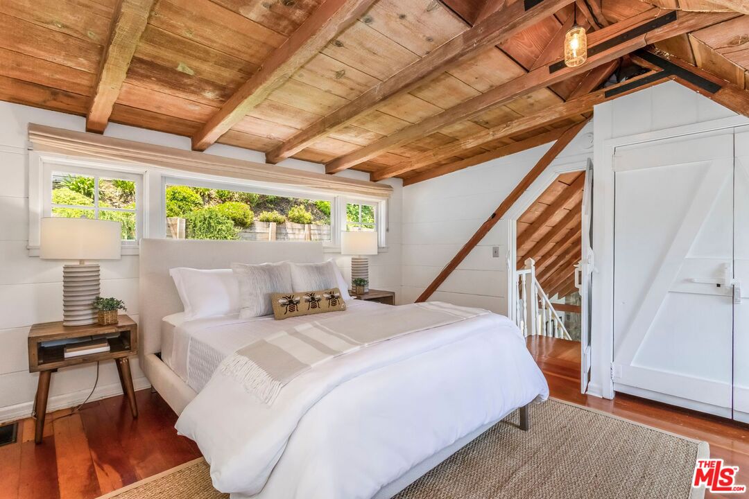 3940 Davana Road Sherman Oaks, CA 91423 - Photo 24 of 60 a bedroom with a bed and a wooden floor