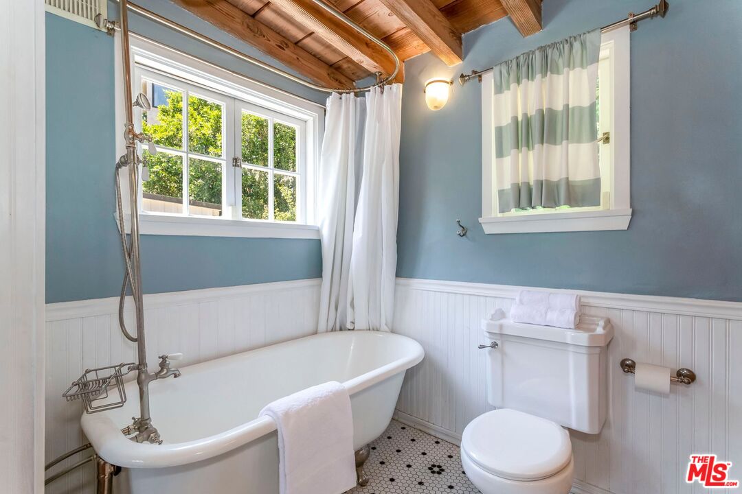 3940 Davana Road Sherman Oaks, CA 91423 - Photo 27 of 60 a white bath tub sitting next to a white toilet