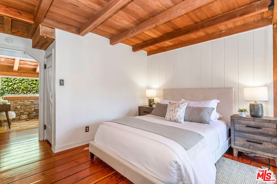 3940 Davana Road Sherman Oaks, CA 91423 - Photo 28 of 60 a bedroom with a bed and wooden floor