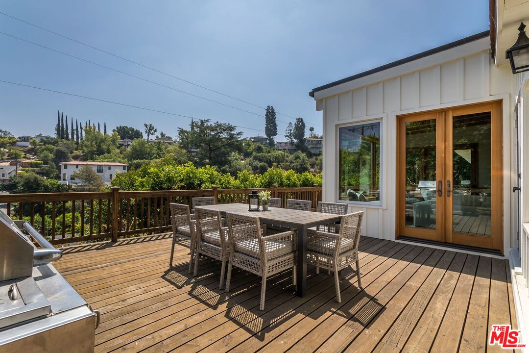 3940 Davana Road Sherman Oaks, CA 91423 - Photo 52 of 60 a patio with wooden floor table and chairs