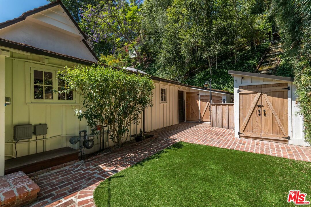 3940 Davana Road Sherman Oaks, CA 91423 - Photo 53 of 60 a view of a backyard with plants and large trees with wooden fence