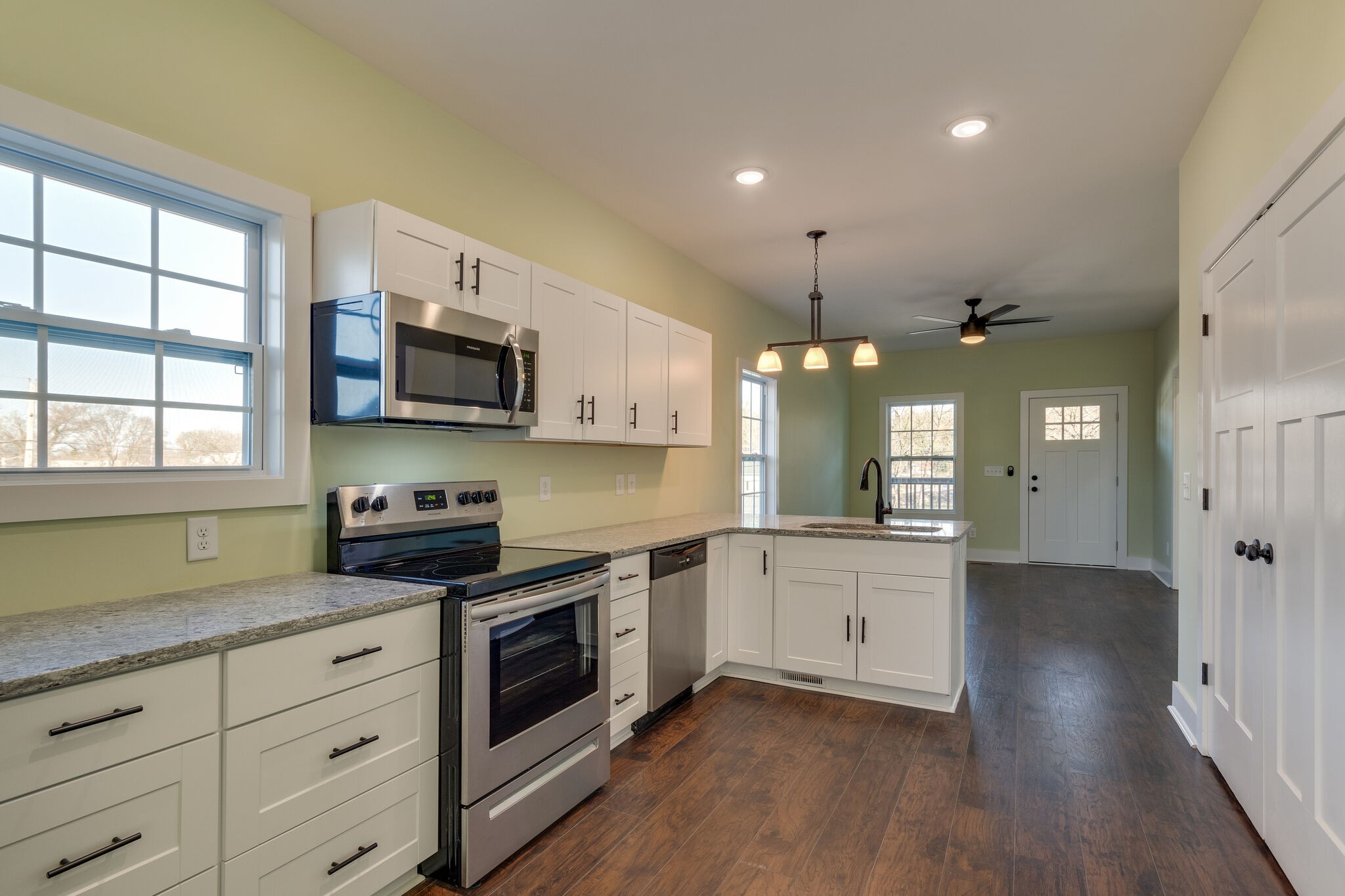 1004 Bridge Street Columbia, TN 38401 - Photo 11 of 25 a kitchen with stainless steel appliances white cabinets and a wooden floor