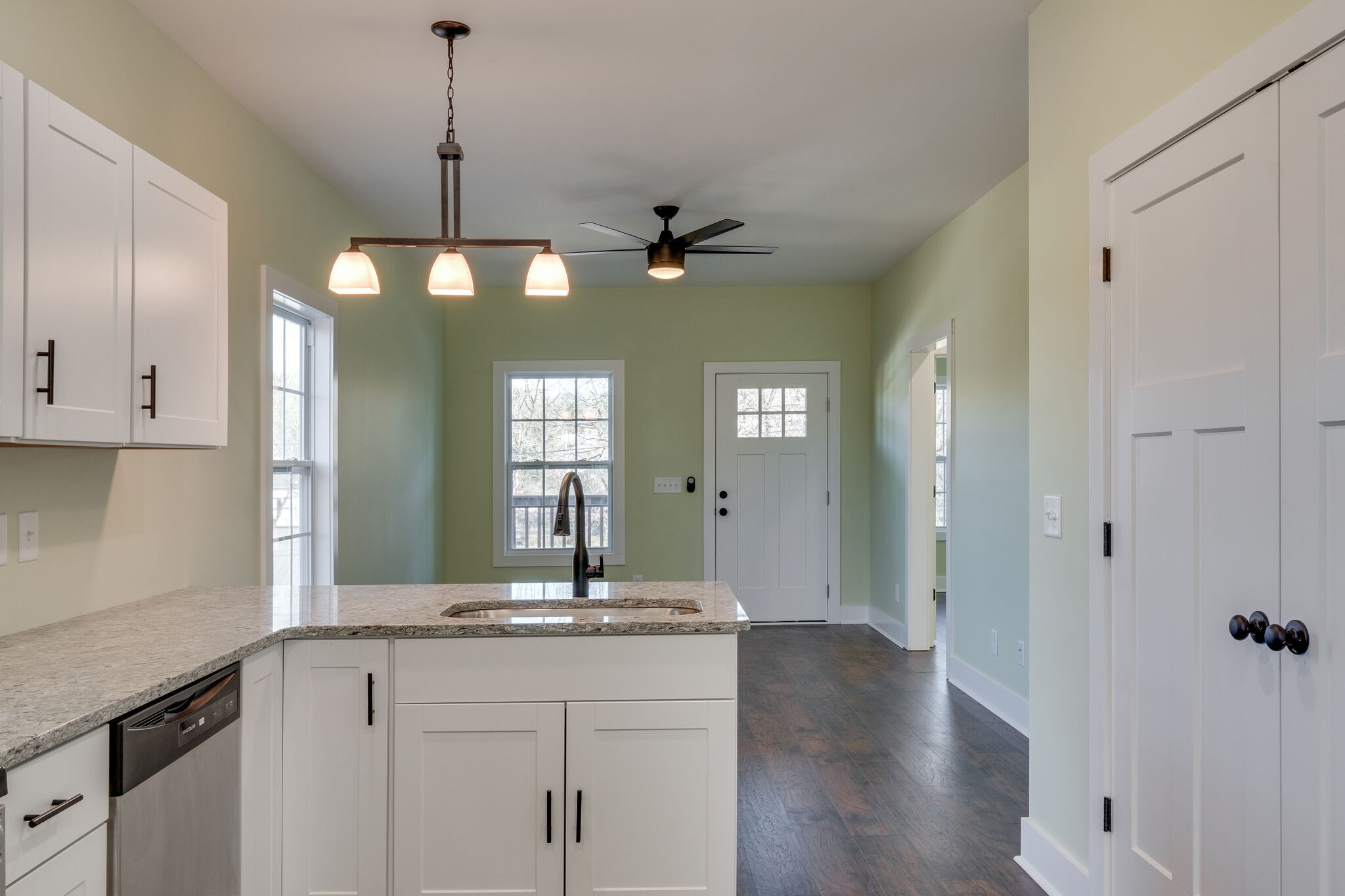 1004 Bridge Street Columbia, TN 38401 - Photo 12 of 25 a view of a kitchen with a sink and dishwasher with wooden floor