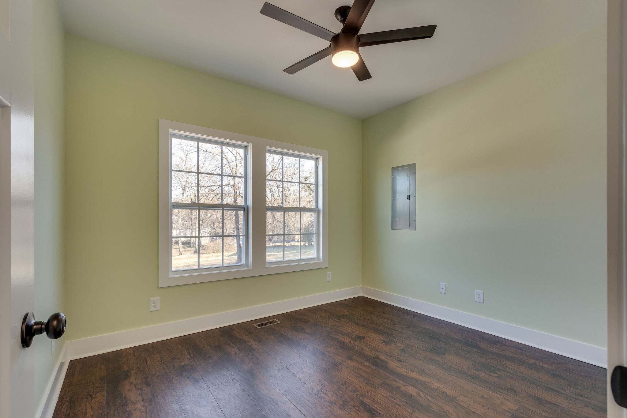 1004 Bridge Street Columbia, TN 38401 - Photo 19 of 25 an empty room with wooden floor ceiling fan and windows