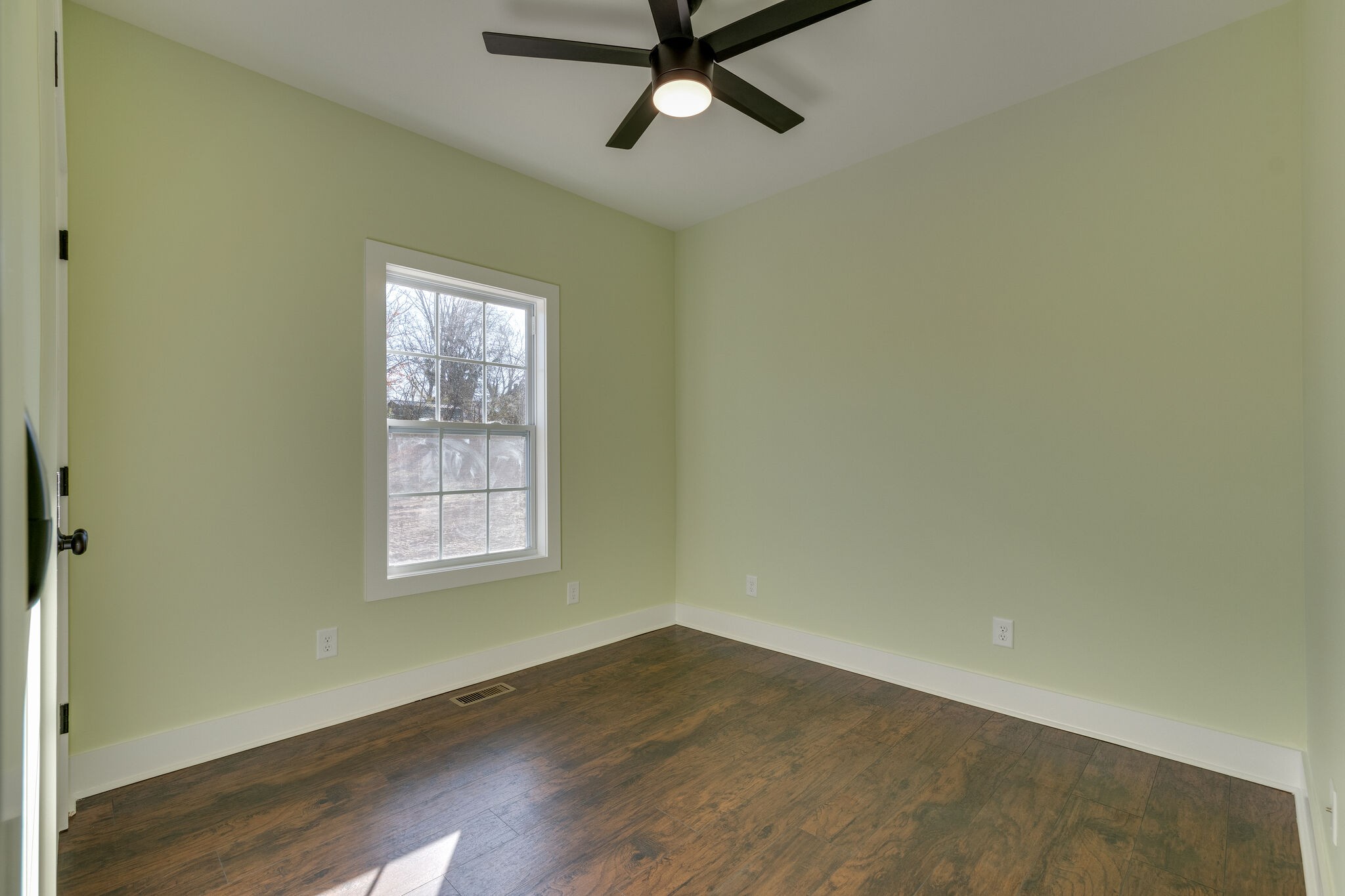 1004 Bridge Street Columbia, TN 38401 - Photo 21 of 25 an empty room with wooden floor fan and windows