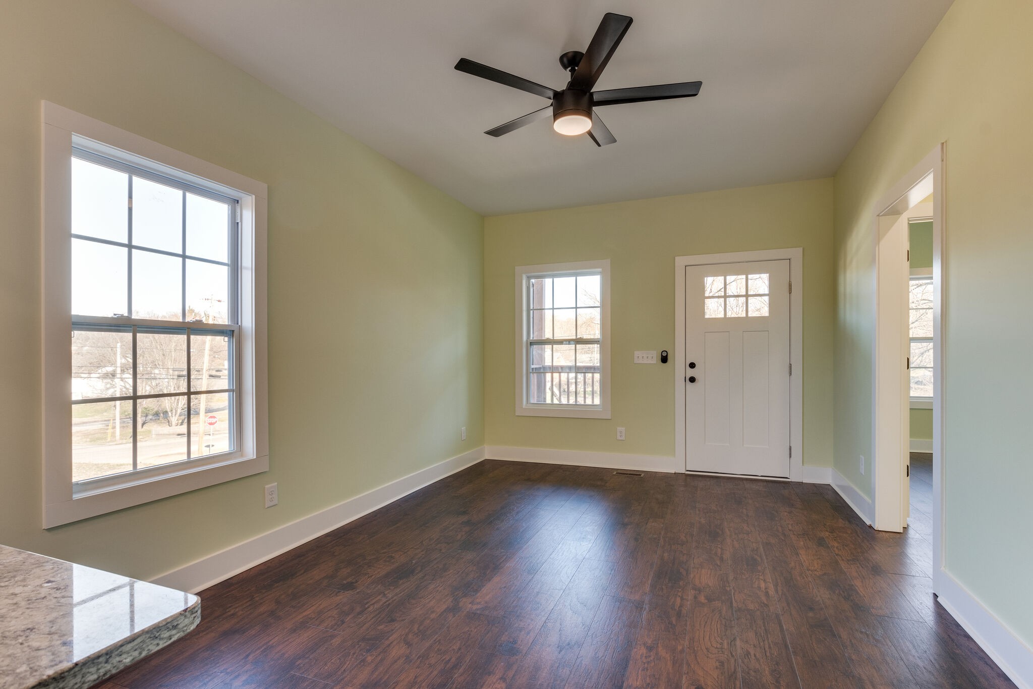 1004 Bridge Street Columbia, TN 38401 - Photo 7 of 25 an empty room with wooden floor and windows
