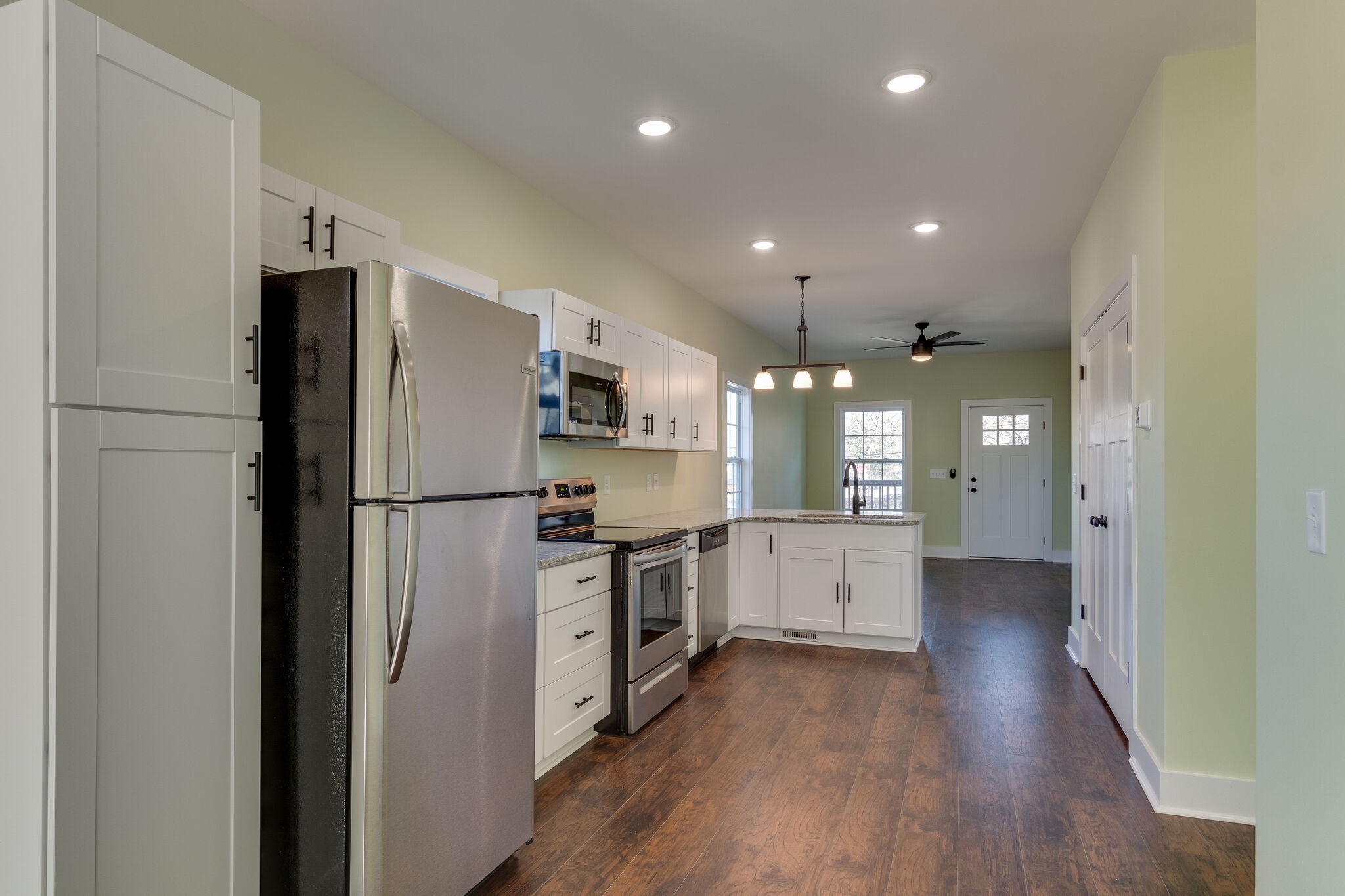 1004 Bridge Street Columbia, TN 38401 - Photo 10 of 25 a kitchen with white cabinets and stainless steel appliances