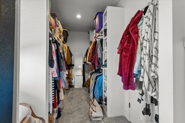 a bedroom with a bed and ceiling fan