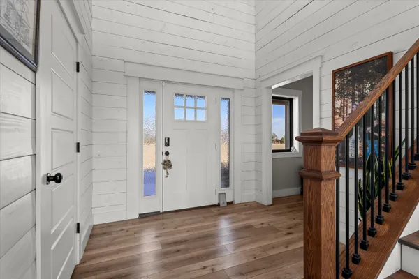 a living room with furniture and a view of kitchen