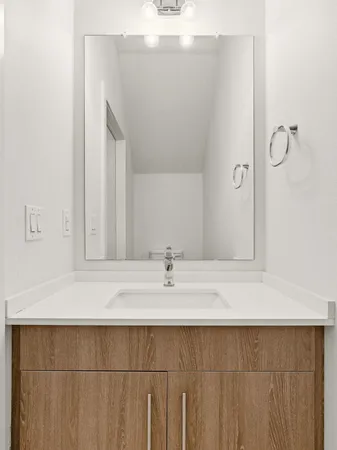a bathroom with a sink and vanity