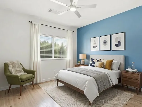 a bedroom with a bed and a chair
