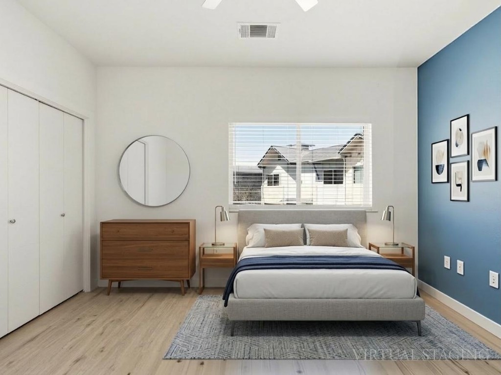 7805 Cooper Lane, Unit 608 Austin, TX 78745 - Photo 15 of 31 a bedroom with a bed a mirror and a window