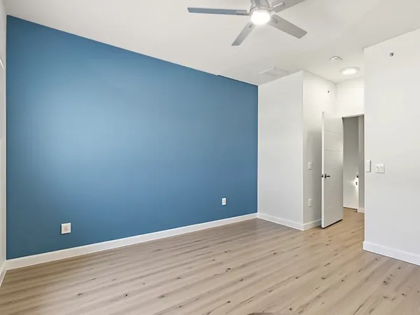 a view of an empty room with wooden floor