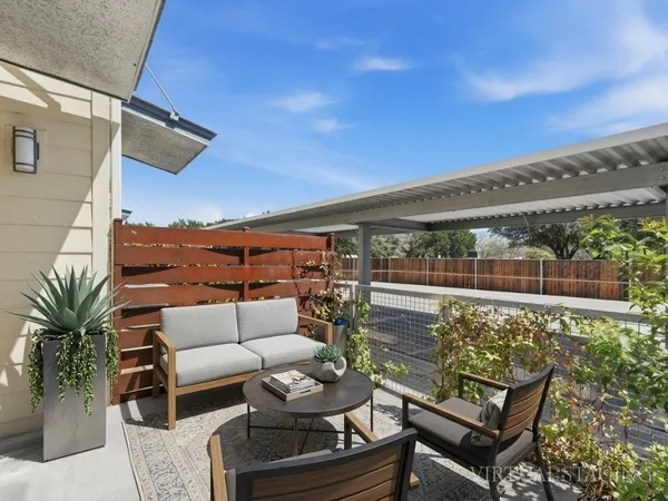 a outdoor living space with furniture and city view