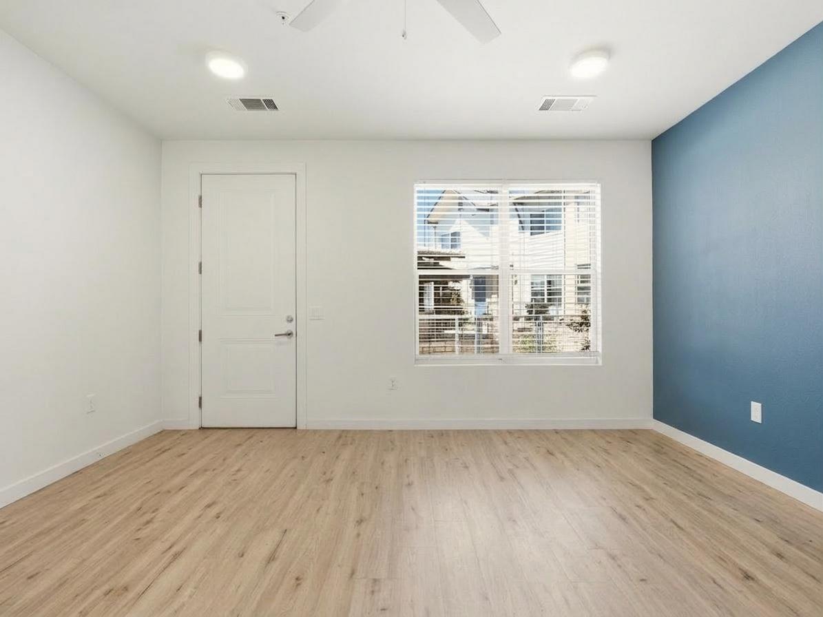 7805 Cooper Lane, Unit 608 Austin, TX 78745 - Photo 4 of 31 an empty room with wooden floor and windows