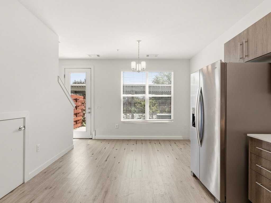7805 Cooper Lane, Unit 608 Austin, TX 78745 - Photo 7 of 31 a view of an empty room with wooden floor and a window