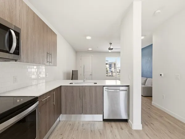 a kitchen with stainless steel appliances granite countertop a stove and a sink