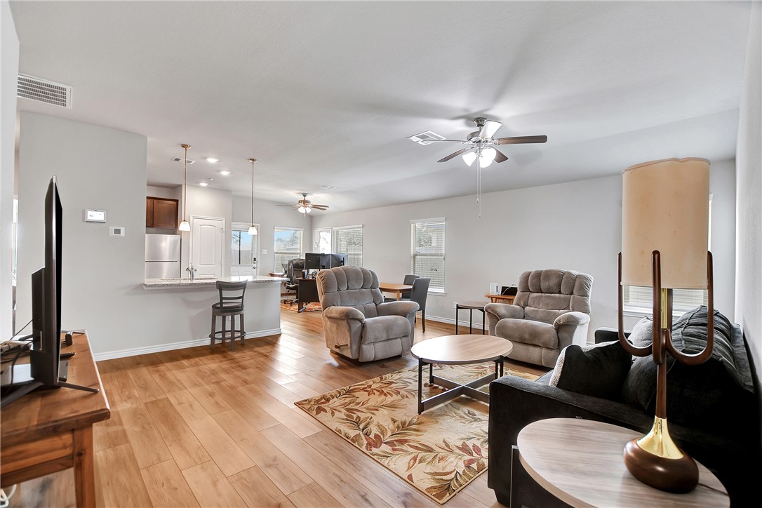 909 Davy Street Brenham, TX 77833 - Photo 7 of 35 Living area featuring light wood-style floors and a ceiling fan