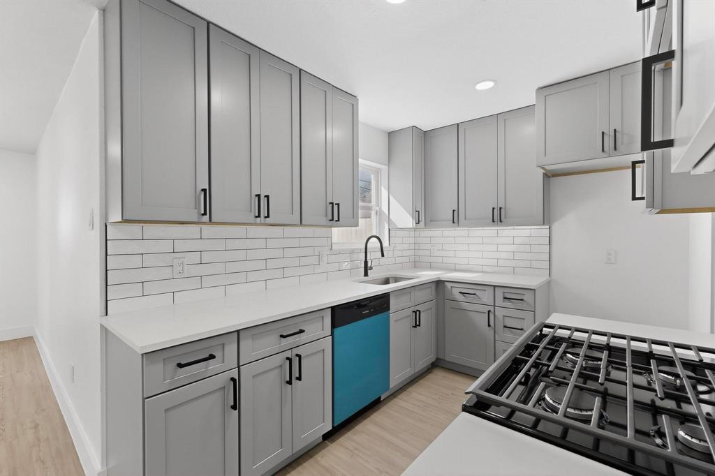 3318 Ridgefield Street Irving, TX 75062 - Photo 11 of 33 a kitchen with a sink stove and cabinets