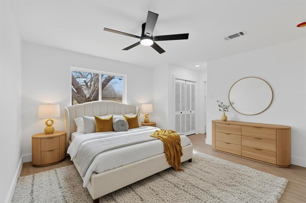 3318 Ridgefield Street Irving, TX 75062 - Photo 13 of 33 a bedroom with a bed a mirror and paintings on the wall