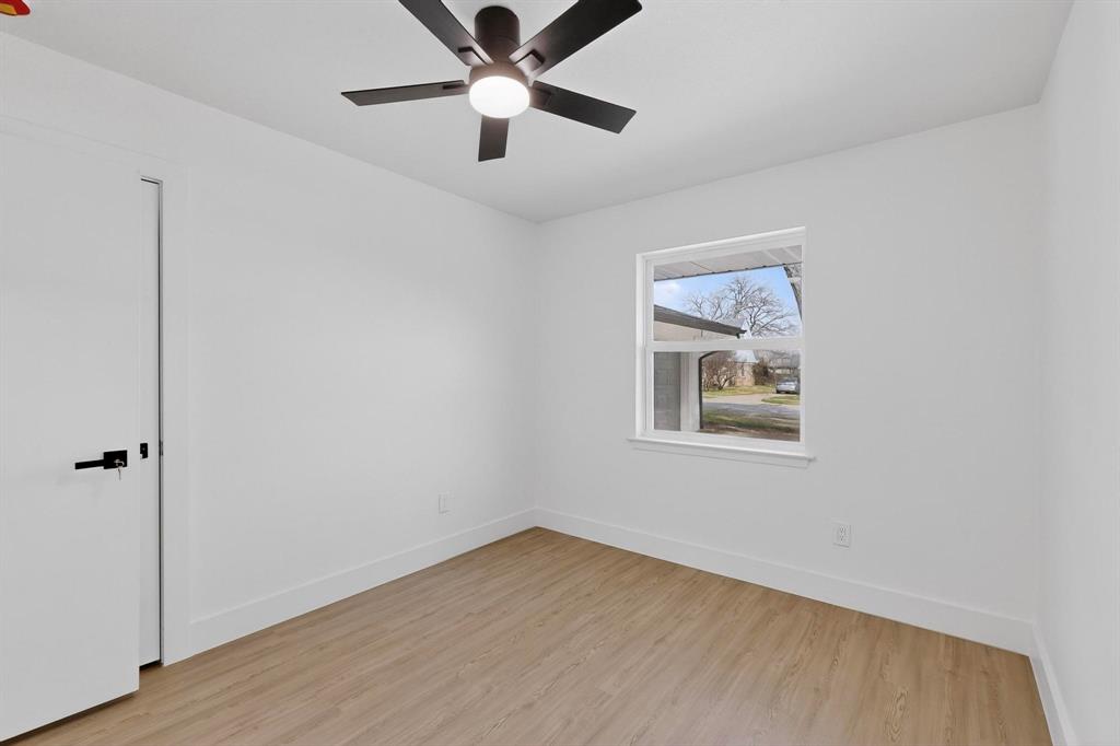 3318 Ridgefield Street Irving, TX 75062 - Photo 23 of 33 wooden floor in an empty room with a window