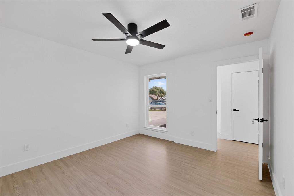 3318 Ridgefield Street Irving, TX 75062 - Photo 26 of 33 an empty room with wooden floor closet and windows