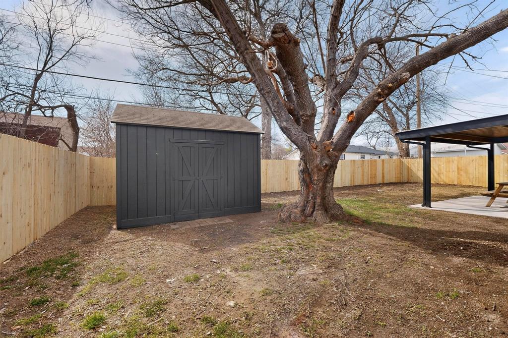 3318 Ridgefield Street Irving, TX 75062 - Photo 32 of 33 a view of a house with a large tree and wooden fence