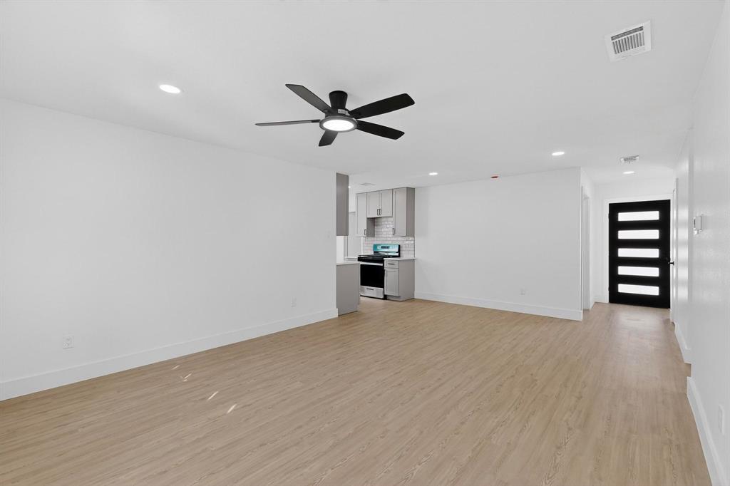 3318 Ridgefield Street Irving, TX 75062 - Photo 6 of 33 a view of empty room with wooden floor and ceiling fan