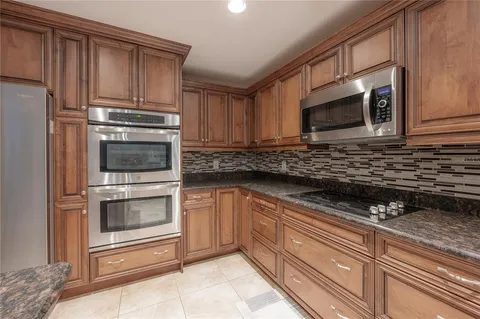 a view of yard with swimming pool and trees in the background