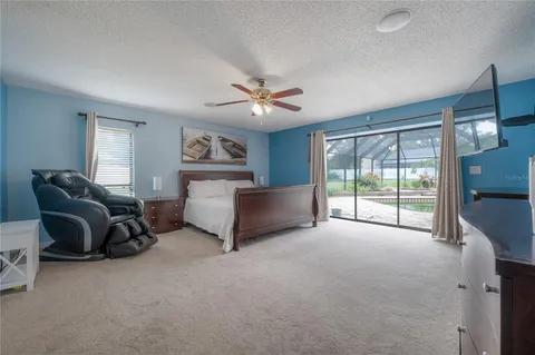 a living room with furniture and a ceiling fan
