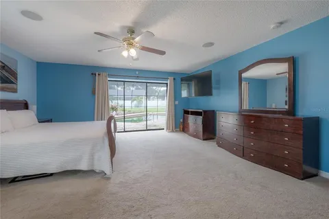 a view of a dining room with furniture water view and a floor to ceiling window