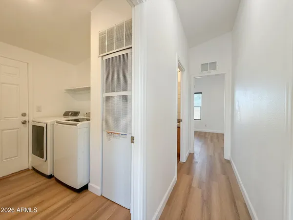 a view of a storage and utility room with washer and dryer