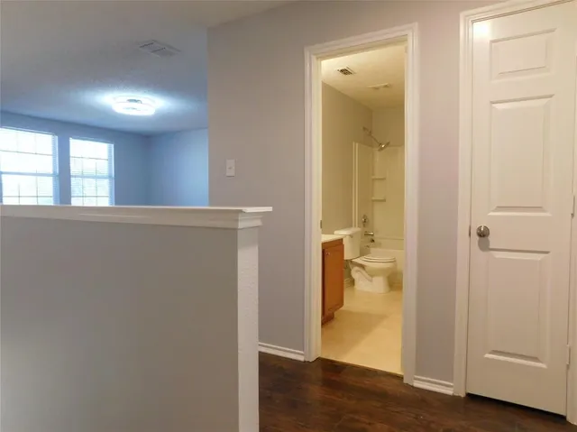 an empty room and wooden floor with windows