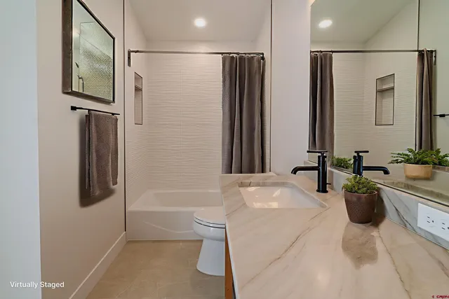 a bathroom with a sink toilet and tub
