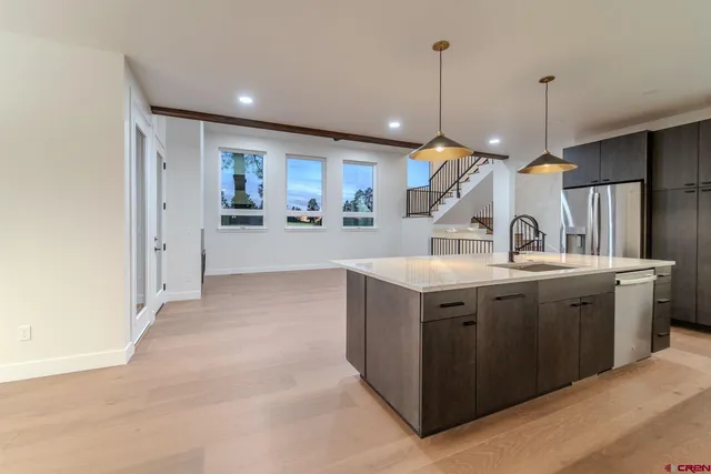 a kitchen with kitchen island a sink stove and refrigerator