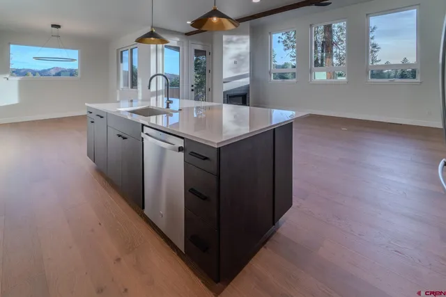 a kitchen with a sink cabinets and wooden floor