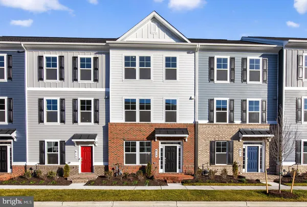a front view of a residential apartment building with a yard