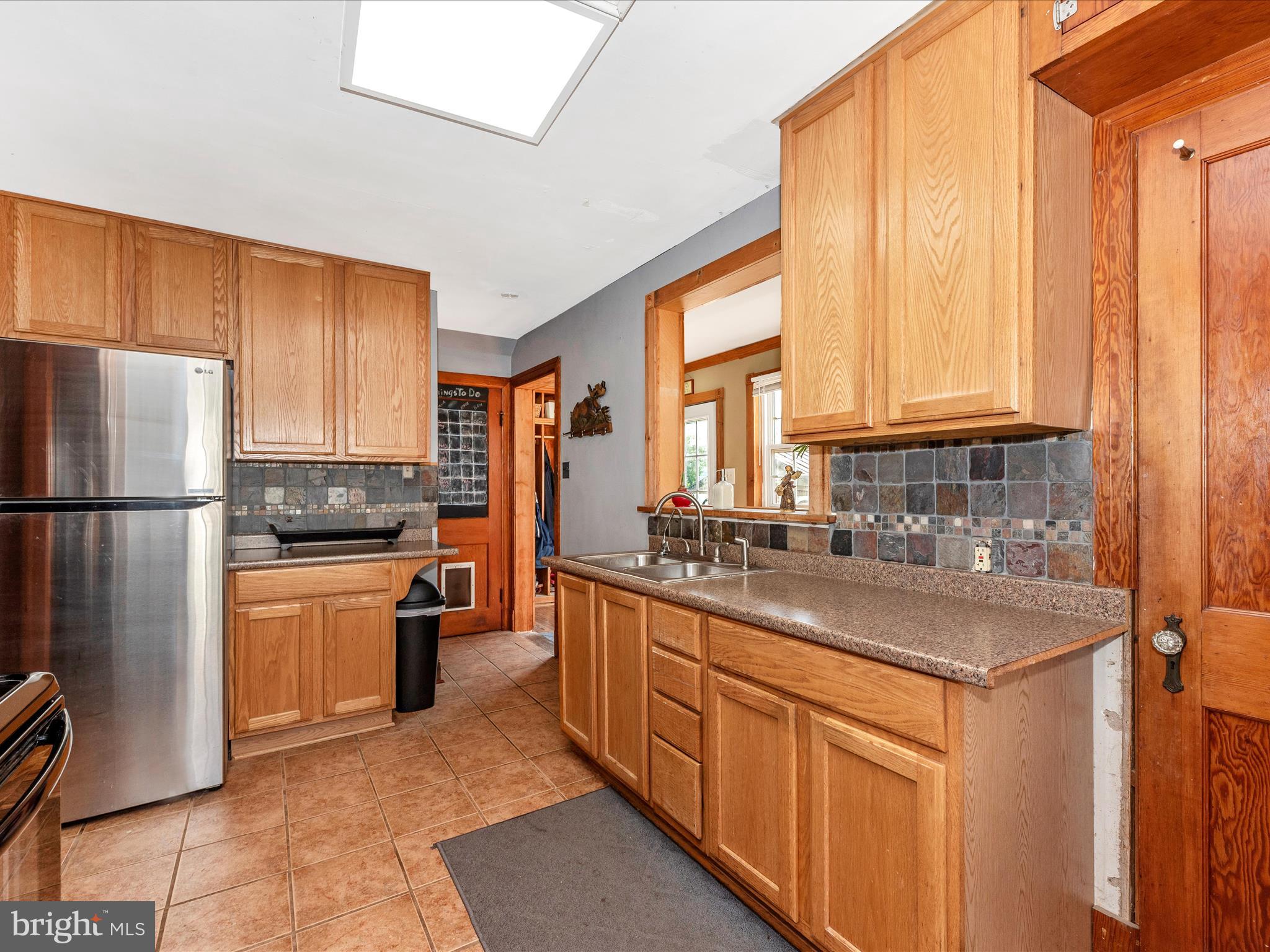 6103 Jefferson Pike Frederick, MD 21703 - Photo 18 of 57 a kitchen with stainless steel appliances granite countertop a refrigerator sink and cabinets